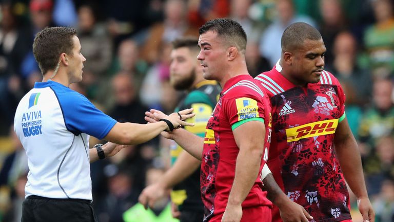 NORTHAMPTON, ENGLAND - SEPTEMBER 30:  Luke Pearce, the referee talks to Harlequins captain Dave Ward as a penalty is awarded against Kyle Sinckler (R).