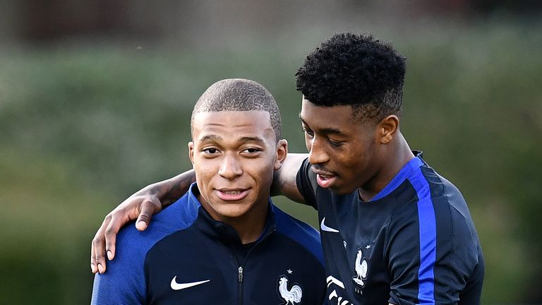 France's forward Kylian Mbappe jokes with France's defender Presnel Kimpembe during a training session in Clairefontaine-en-Yvelines on October 3, 2017, in