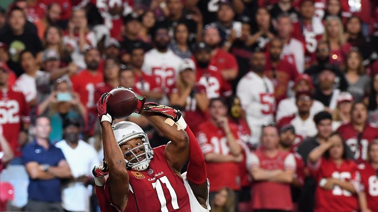 GLENDALE, AZ - OCTOBER 01:  Wide receiver Larry Fitzgerald #11 of the Arizona Cardinals catches the game winning touchdown during overtime in the NFL game 