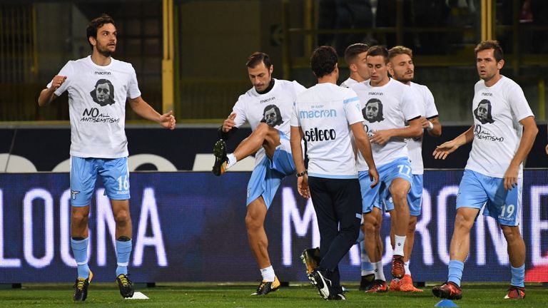 Lazio's players showing image of holocaust victim Anne Frank, warm up prior the Italian Serie A football match v Bologna