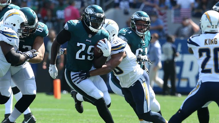 CARSON, CA - OCTOBER 01:  Charmeachealle Moore #50 of the Los Angeles Chargers tackles LeGarrette Blount #29 of the Philadelphia Eagles during the first ha