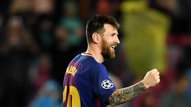 Lionel Messi celebrates scoring his 100th European goal in the 3-1 win over Olympiakos