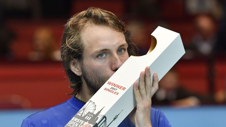 Lucas Pouille of France kisses the trophy after winning against Jo-Wilfried Tsonga of France in their men's singles final match during the ATP tournament i