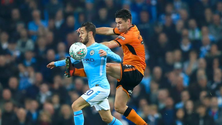 Manchester City's Bernardo Silva (left) and Wolves' Ben Marshall battle for the ball during the Carabao Cup, Fourth Round match at the Etihad