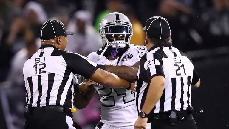 OAKLAND, CA - OCTOBER 19:  Marshawn Lynch #24 of the Oakland Raiders is restrained after coming off the bench and shoving a referee during a scrum with the