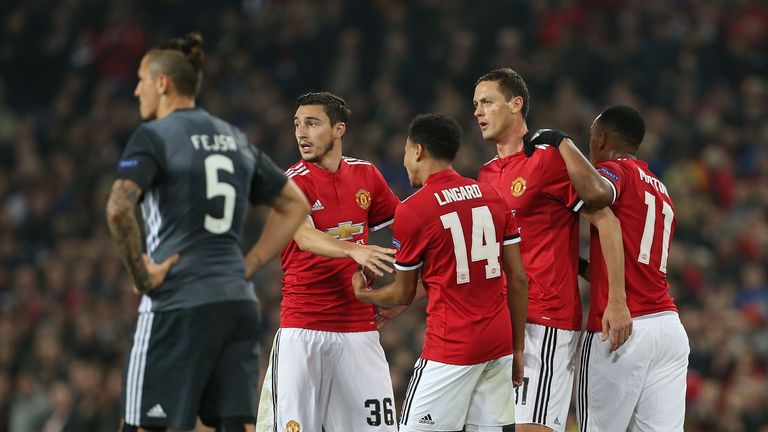 Manchester United players celebrate after taking the lead against Benfica