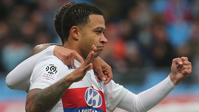 Lyon's forward Memphis Depay celebrates after scoring during the Ligue 1 football match between Troyes and 