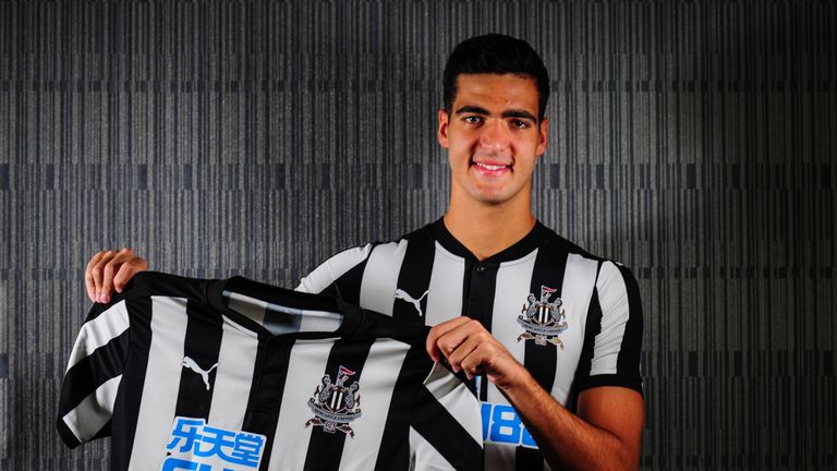 Mikel Merino poses for a photograph holding a Newcastle home shirt after signing a permanent contract