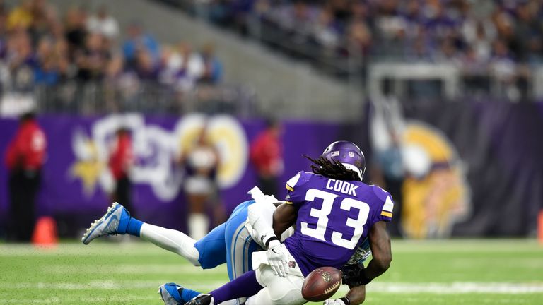 Dalvin Cook #33 fumbles the ball while being tackled by Tavon Wilson #32 of the Detroit LionS