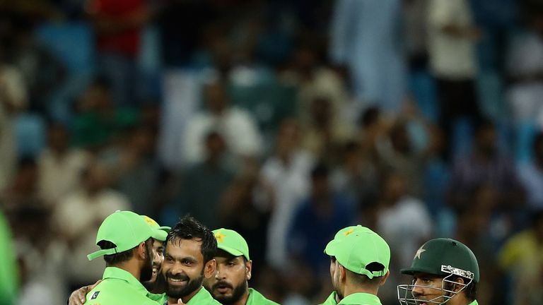 DUBAI, UNITED ARAB EMIRATES - OCTOBER 13:  Mohammad Hafeez of Pakistan celebrates with teammates after dismissing Upul Tharanga of Sri Lanka during the fir