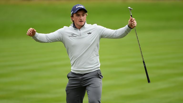 Paul Dunne of Ireland celebrates after chipping in on the 18th hole to win the British Masters