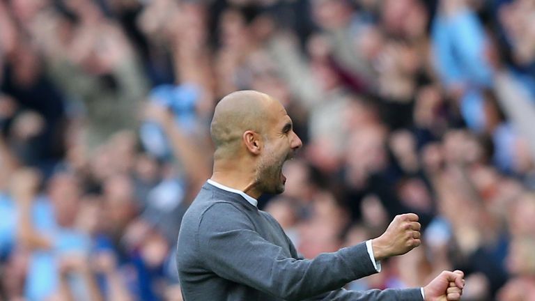 MANCHESTER, ENGLAND - OCTOBER 14: Josep Guardiola, Manager of Manchester City celebrates his team's opening goal during the Premier League match between Ma