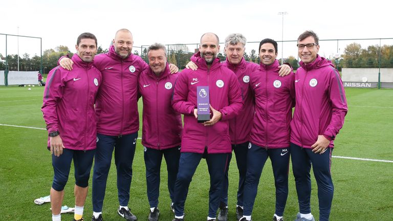 Pep Guardiola and his coaching staff pose with the Manager of the Month Award for September 2017