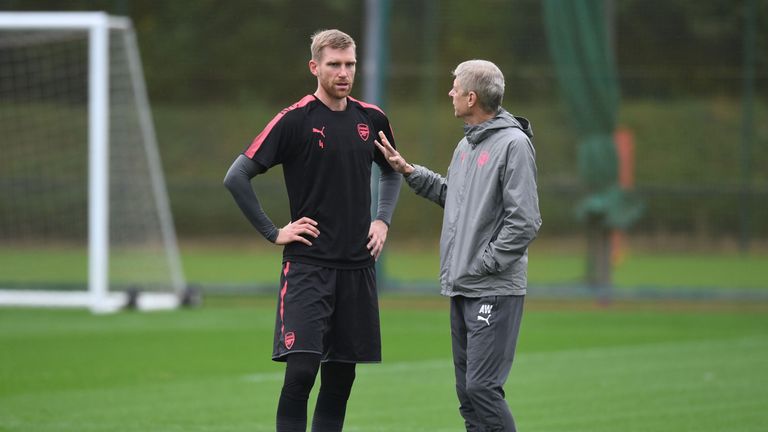 Per Mertesacker and Arsene Wenger at Arsenal training