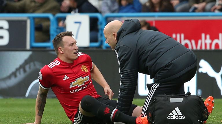 Phil Jones receives treatment after picking up an injury during Manchester United's defeat at Huddersfield