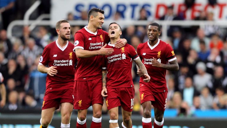 Liverpool's Philippe Coutinho celebrates scoring his side's first goal of the game with his team-mates during the Premier League match at Newcastle