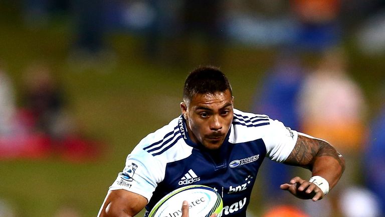 Pita Ahki of the Blues  is tackled by S' bura Sithole of the Sharks 