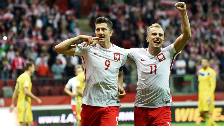 Robert Lewandowski (L) celebrates scoring his side's third goal during the FIFA World Cup 2018 qualification match between Poland and Kazakhstan