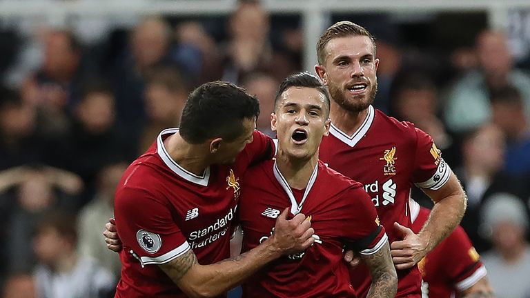 Philippe Coutinh is congratulated by Dejan Lovren and Jordan Henderson after opening the scoring at St James' Park