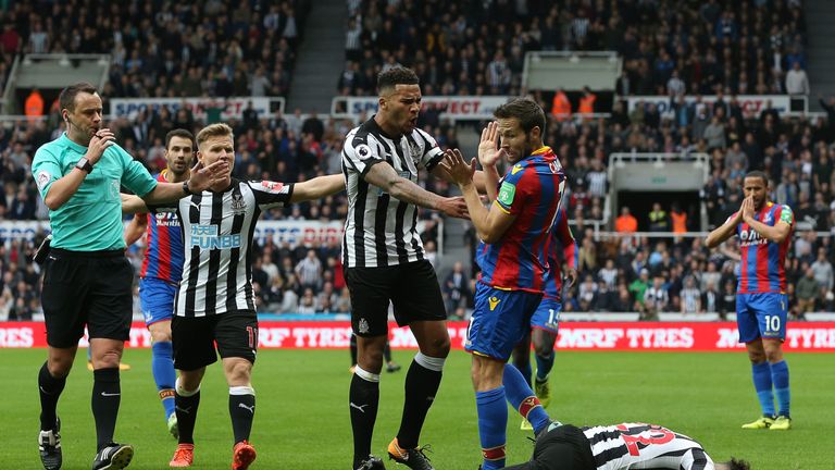NEWCASTLE UPON TYNE, ENGLAND - OCTOBER 21:  Jamaal Lascelles of Newcastle United confronts Yohan Cabaye of Crystal Palace as Deandre Yedlin of Newcastle Un