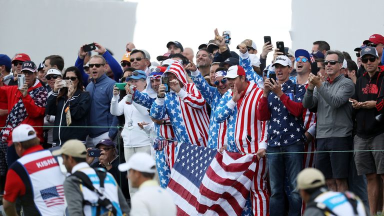 Fans of the U.S. Team cheer on the 16th hole during Saturday foursome matches of the Presidents Cup at Liberty National