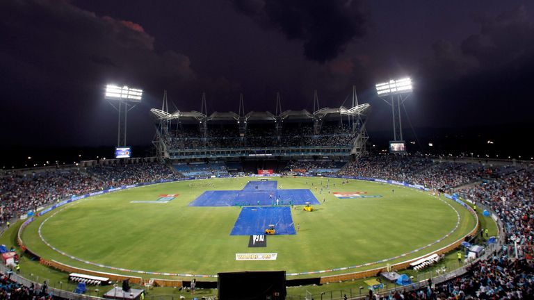 The pitch is seen covered during a heavy downpour, delaying the start of the IPL Twenty20 cricket match between Pune Warriors India and Royal Challengers B