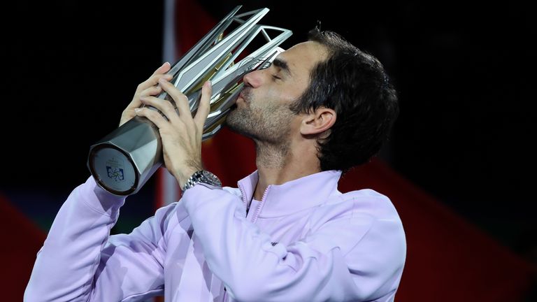 Roger Federer of Switzerland kiss the winner's trophy after defeating Rafael Nadal of Spain