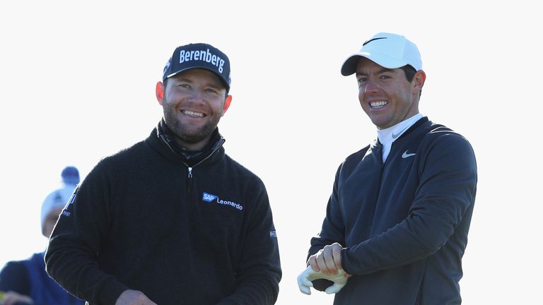 ST ANDREWS, SCOTLAND - OCTOBER 05:  Rory McIlroy of Northern Ireland and Branden Grace of South Africa share a joke during day one of the 2017 Alfred Dunhi