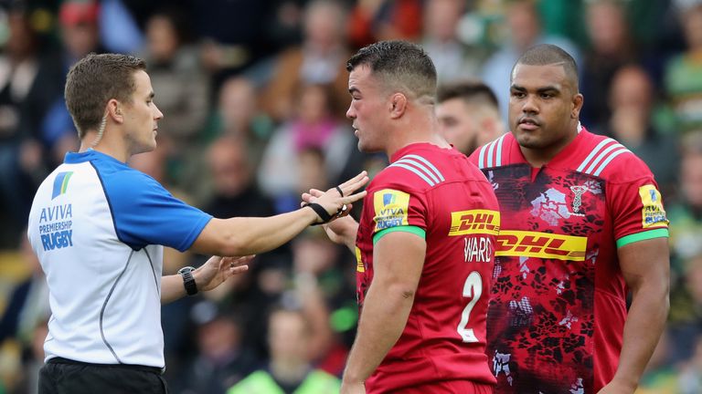 Referee Luke Pearce talks to Harlequins captain Dave Ward (left) as a penalty is awarded against Kyle Sinckler