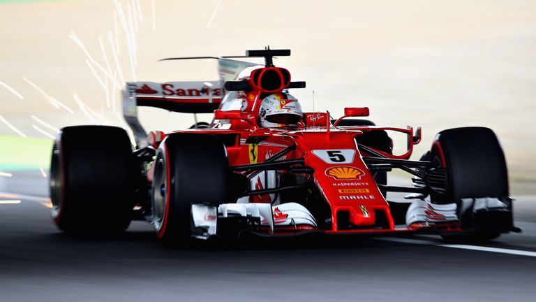 SUZUKA, JAPAN - OCTOBER 06: Sparks fly behind Sebastian Vettel of Germany driving the (5) Scuderia Ferrari SF70H on track during practice for the Formula O