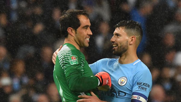 Manchester City's Argentinian striker Sergio Aguero (R) who scored the winning penalty celebrates with Manchester City's Chilean goalkeeper Claudio Bravo, 