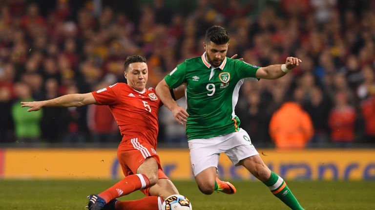 DUBLIN, IRELAND - MARCH 24:  James Chester of Wales stretches to tackle Shane Long of the Republic of Ireland during the FIFA 2018 World Cup Qualifier betw