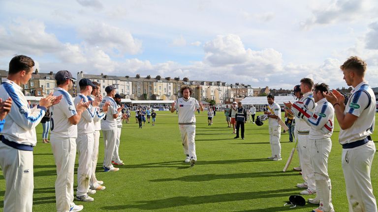Ryan Sidebottom receives a guard of honour from his Yorkshire team-mates. 