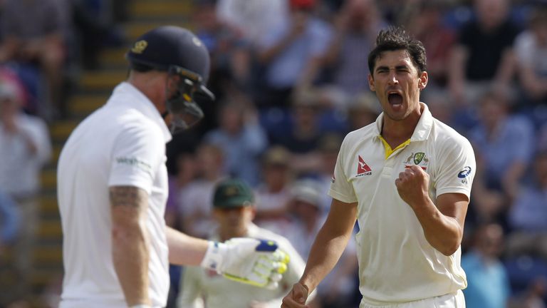 Australias Mitchell Starc (R) celebrates bowling Englands Ben Stokes during play on the third day of the opening Ashes cricket test match between England a