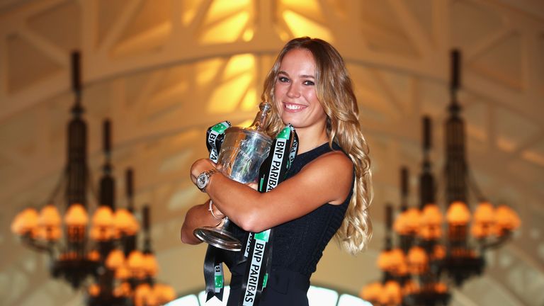 Champion Caroline Wozniacki of Denmark poses with the Billie Jean King trophy after her victory against Venus Williams