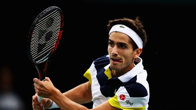 Pierre-Hugues Herbert of France returns a backhand against Feliciano Lopez of Spain during Day 2 of the Rolex Paris Masters