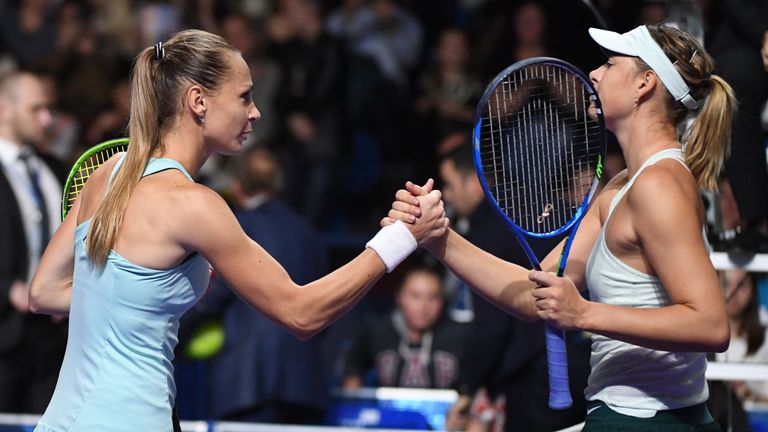 Russia's Maria Sharapova (R) shakes hands with Slovakia's Magdalena Rybarikova after losing their women's singles first round tennis match at the Kremlin C