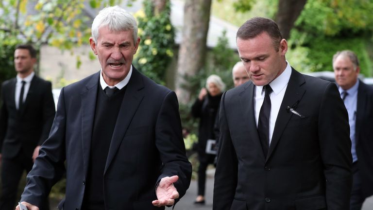 Former Newcastle player Terry McDermott speaks to Wayne Rooney after the service
