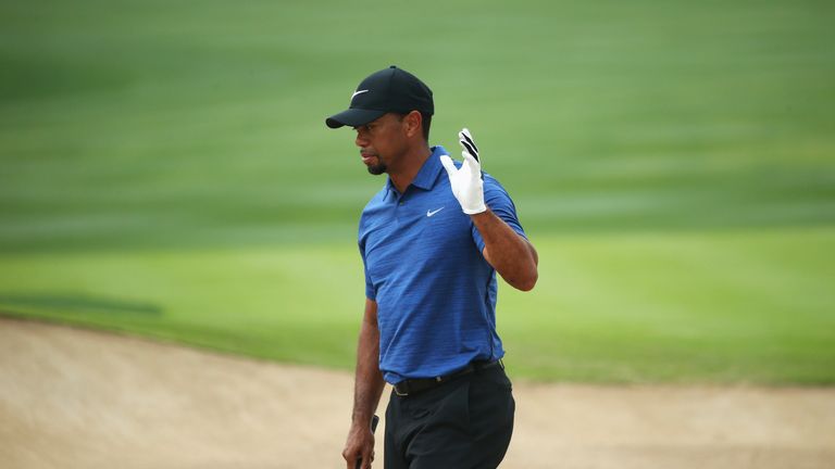 DUBAI, UNITED ARAB EMIRATES - FEBRUARY 02:  Tiger Woods of the United States acknowledges the crowd as he plays from a bunker on the 6th hole during the fi