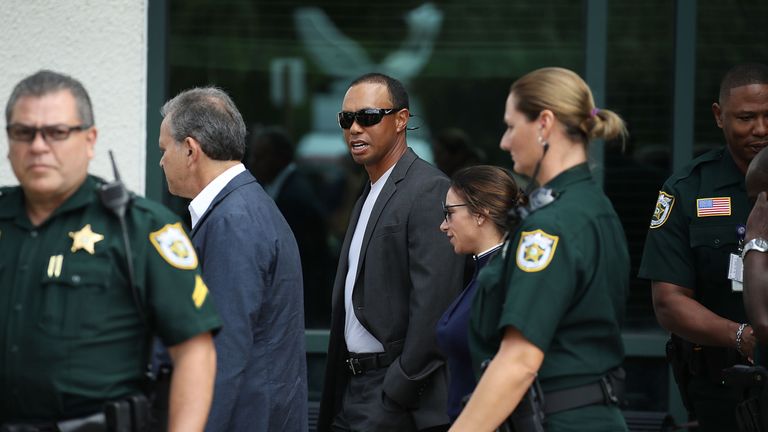 Tiger Woods leaves the North County Courthouse after pleading guilty to a charge of reckless driving