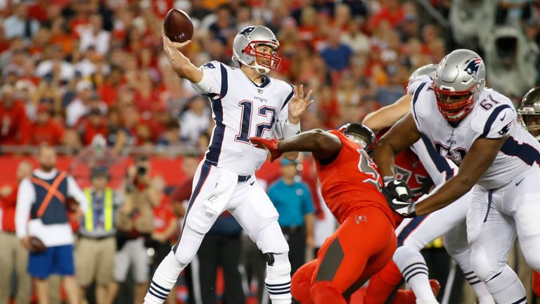 TAMPA, FL - OCTOBER 5:  Quarterback Tom Brady #12 of the New England Patriots throws to an open receiver during the first quarter of an NFL football game a