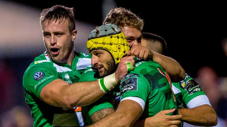 Treviso players celebrate an Angelo Esposito try