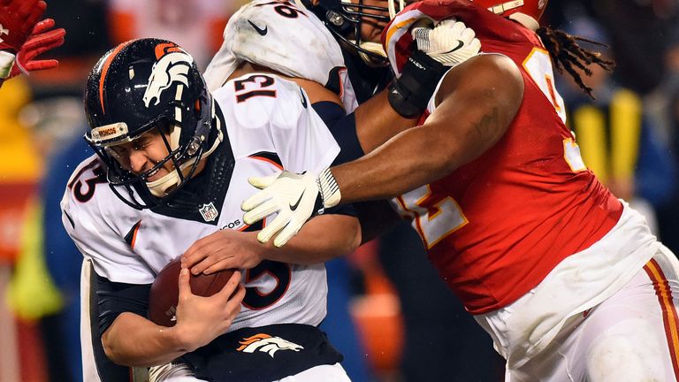 KANSAS CITY, MO - DECEMBER 25:  Quarterback Trevor Siemian #13 of the Denver Broncos is hit by nose tackle Dontari Poe #92 of the Kansas City Chiefs during