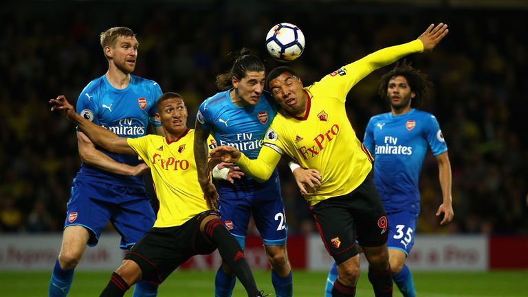 WATFORD, ENGLAND - OCTOBER 14:  Hector Bellerin (2R) and Per Mertesacker of Arsenal (L) battle with Troy Deeney (R) and Richarlison de Andrade of Watford (