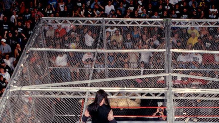 Undertaker surveyed the damage he'd inflicted on Foley after throwing him from the top of the cell for a second time.