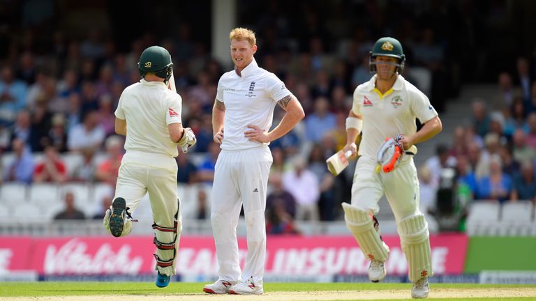 LONDON, ENGLAND - AUGUST 20:  Australia batsman Chris Rogers (l) and  David Warner pick up some as bowler Ben Stokes looks on during day one of the 5th Inv