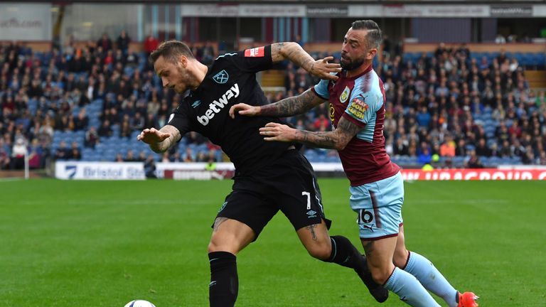 West Ham United's Marko Arnautovic (left) and Burnley's Steven Defour battle for the ball during the Premier League match at Turf Moor