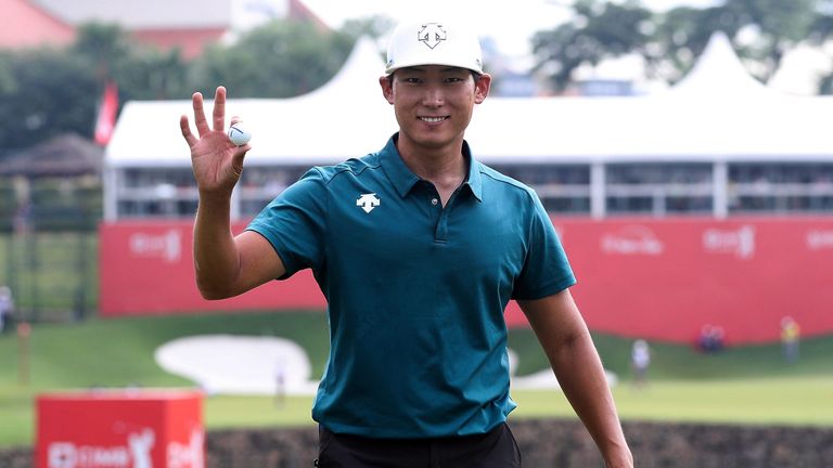 Whee Kim celebrates after winning a new BMW for his ace in Kuala Lumpur
