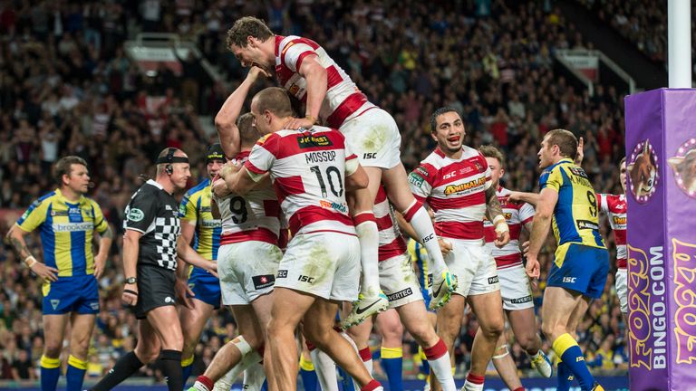 Old Trafford, Manchester, England - Wigan's Blake Green is mobbed by team mates after scoring.