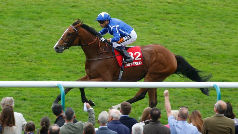 Withhold, ridden by Silvestre de Sousa, leads the field home to win the Betfred Cesarewitch